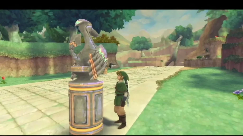 Link stands beside the Forest Temple bird statue on a stone path, with grassy hills around him. Link stands beside the Forest Temple bird statue on a stone path, with grassy hills around him.