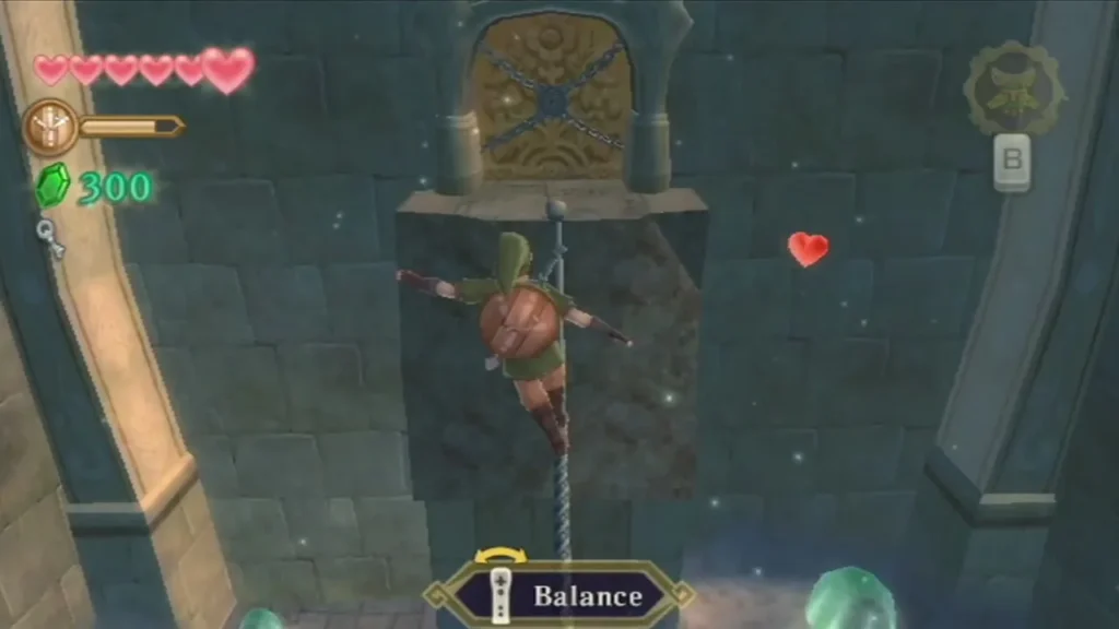 Link hangs on a rope below a golden door bound with chains, with the Balance prompt on screen. Link hangs on a rope below a golden door bound with chains, with the Balance prompt on screen.