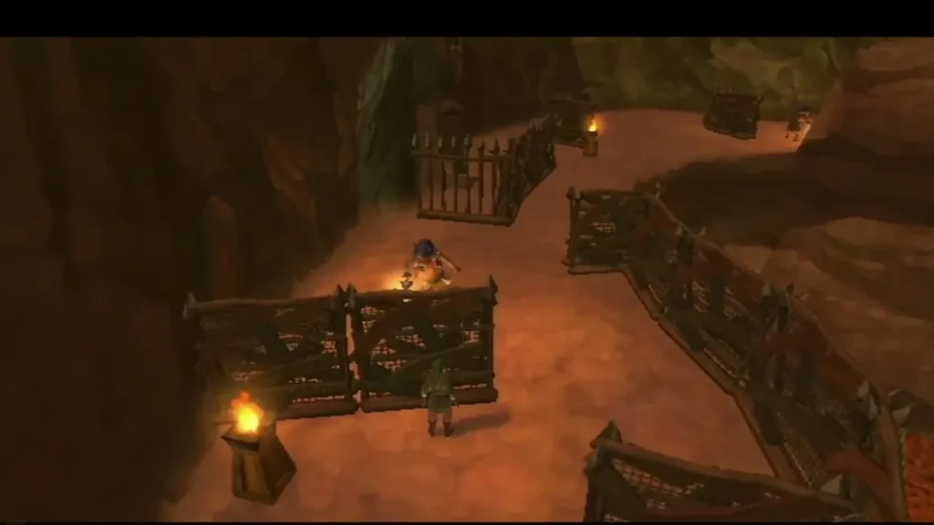 Link hides behind a fence as a Bokoblin guard patrols between two spiked fences.