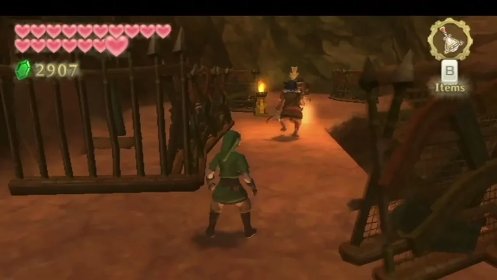 Link waits behind a spiked fence while a Bokoblin with a lantern patrols the path ahead.