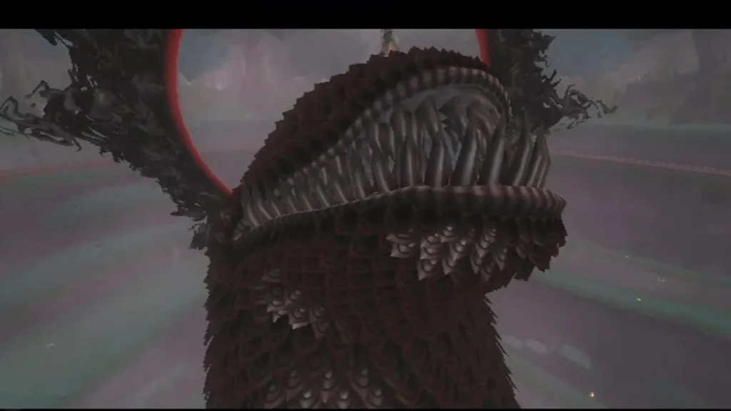 The monster's spiked head and open jaws fill the view, with a red ring behind them
