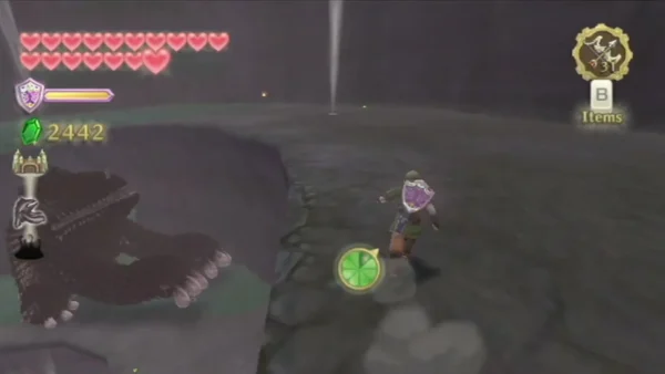Link near one of the Imprisoned's pale clawed limbs on the rocky arena floor. Link near one of the Imprisoned's pale clawed limbs on the rocky arena floor.