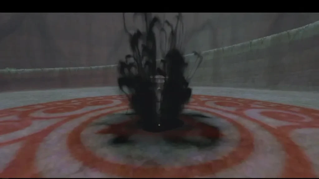 Dark spiked form rising from the red-ringed arena floor as The Imprisoned wakes Dark spiked form rising from the red-ringed arena floor as The Imprisoned wakes
