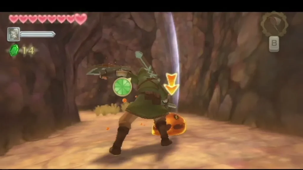Link slashes an orange Chuchu in a narrow lava cave passage. Link slashes an orange Chuchu in a narrow lava cave passage.