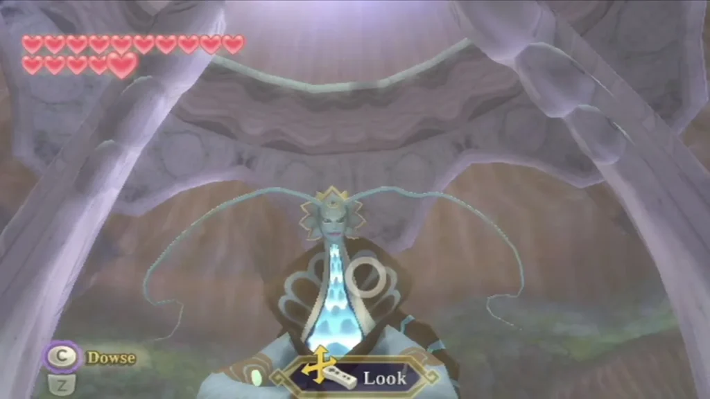 Link looks up at the Water Dragon statue in the Floria shrine, with the Look prompt on screen. Link looks up at the Water Dragon statue in the Floria shrine, with the Look prompt on screen.