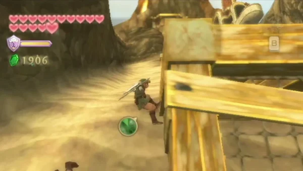 Link crouches beside a wooden plank structure on a sand path in the volcano. Link crouches beside a wooden plank structure on a sand path in the volcano.