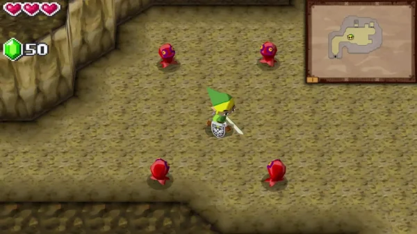 Four red ChuChus surround Link in the tunnel to the Tower of Spirits as he raises his sword Four red ChuChus surround Link in the tunnel to the Tower of Spirits as he raises his sword