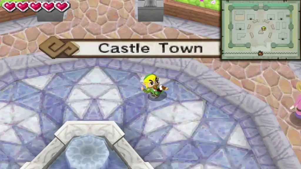 Castle Town title card above Link standing by the fountain in the town square Castle Town title card above Link standing by the fountain in the town square