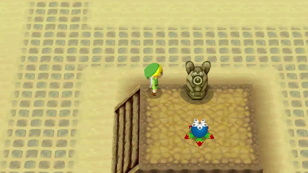 Link stands beside a statue with a bomb flower on the sand Link stands beside a statue with a bomb flower on the sand