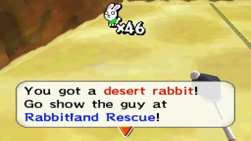Link catches a desert rabbit on the sand, message box shown Link catches a desert rabbit on the sand, message box shown