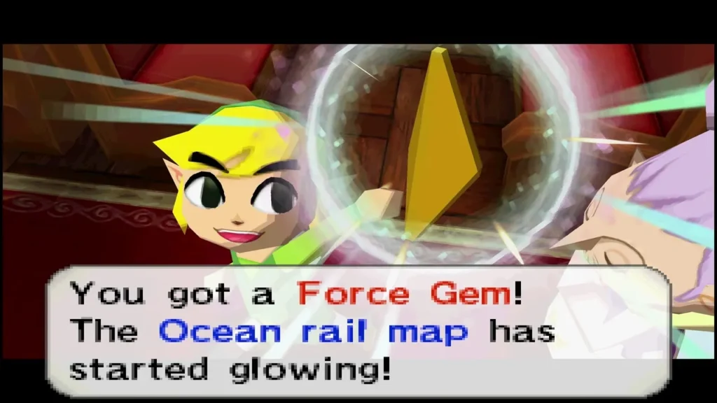 Link holding up a Force Gem with the message that the Ocean rail map has started glowing Link holding up a Force Gem with the message that the Ocean rail map has started glowing