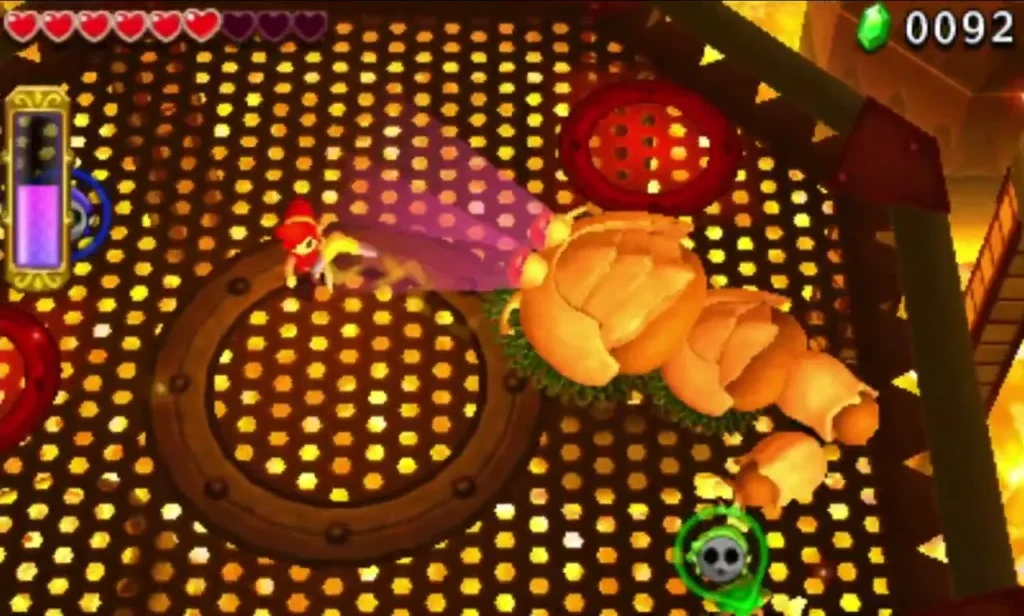 Link strikes the pink-glowing tail of Moldorm on the Fire Temple platform Link strikes the pink-glowing tail of Moldorm on the Fire Temple platform