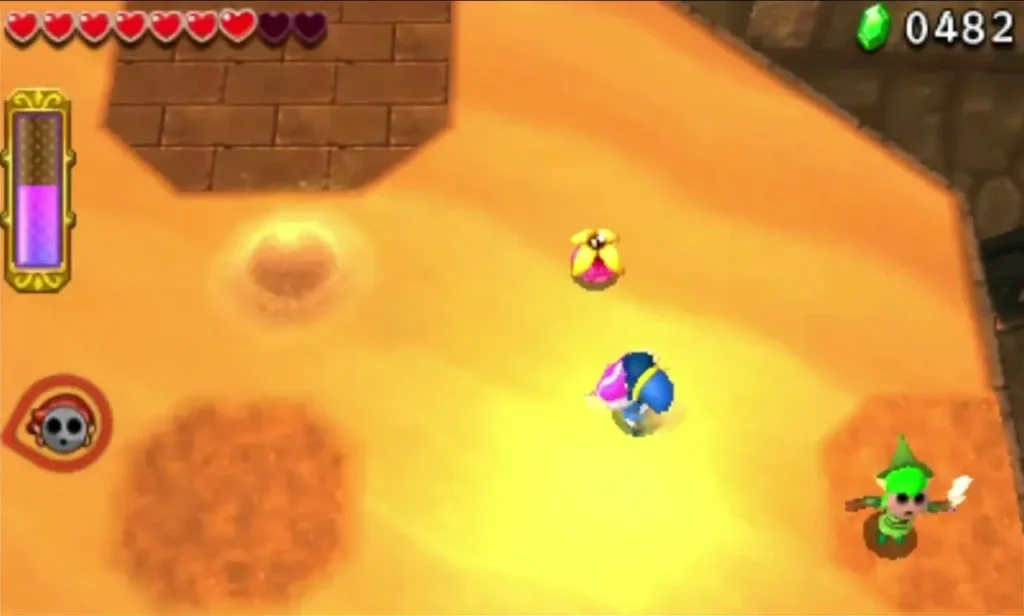 Link on an orange sand floor with sandy pits in the Desert Zone Link on an orange sand floor with sandy pits in the Desert Zone