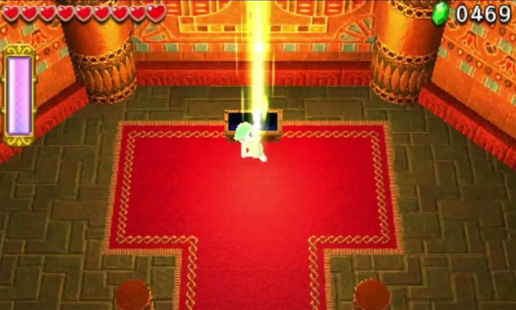 Link stands beside an opening chest in the red Desert Temple end room with golden light rising