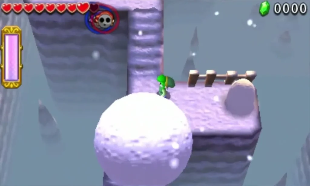 A large snowball and a Link on a snowy ledge in Snowball Ravine, with an enemy above