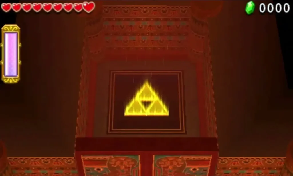 Glowing triforce set into the back wall of a red stone room in the Mausoleo Gibdo Level
