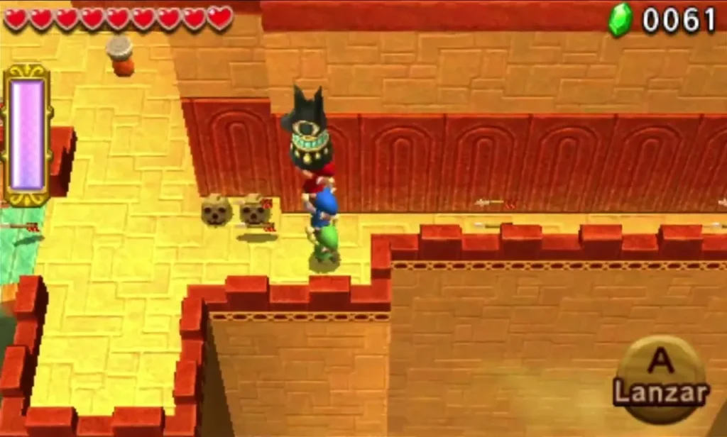 Link lifts a dark Anubis statue overhead on a sandstone path between red-edged walls