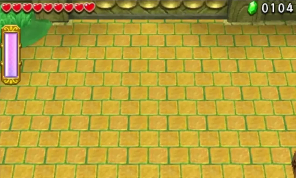 Empty yellow-tiled courtyard of the Forest Temple boss arena with grass at the top left