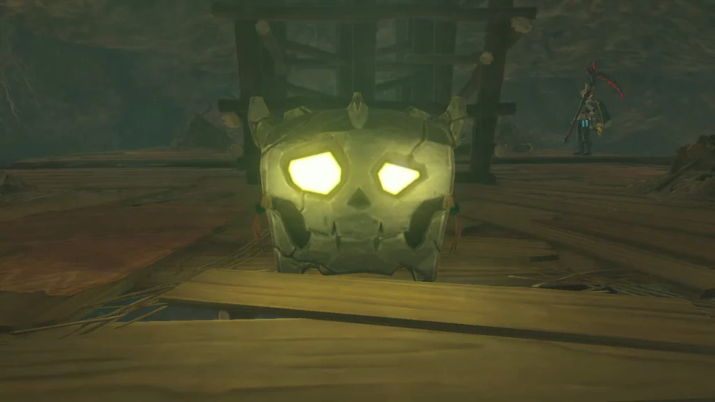 Skull-faced chest glowing yellow on a wooden platform
