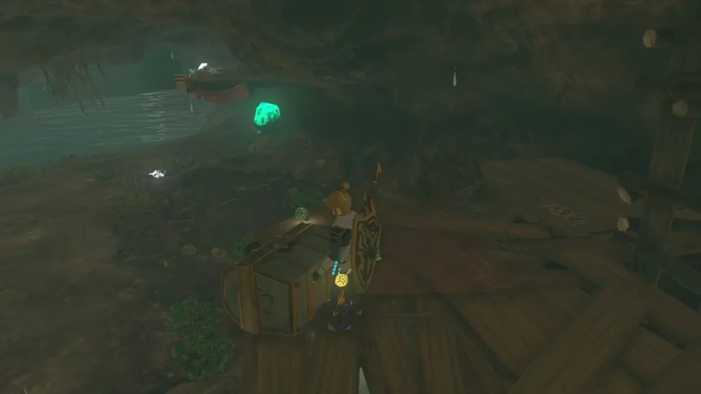 Wooden dock and chest inside the dark cave beside the water Wooden dock and chest inside the dark cave beside the water