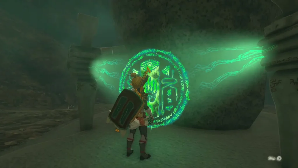 Anedamimik Shrine entrance glowing green in the cave wall Anedamimik Shrine entrance glowing green in the cave wall