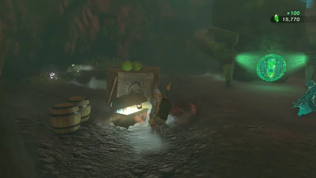 Open chest among barrels and crates in a cave alcove