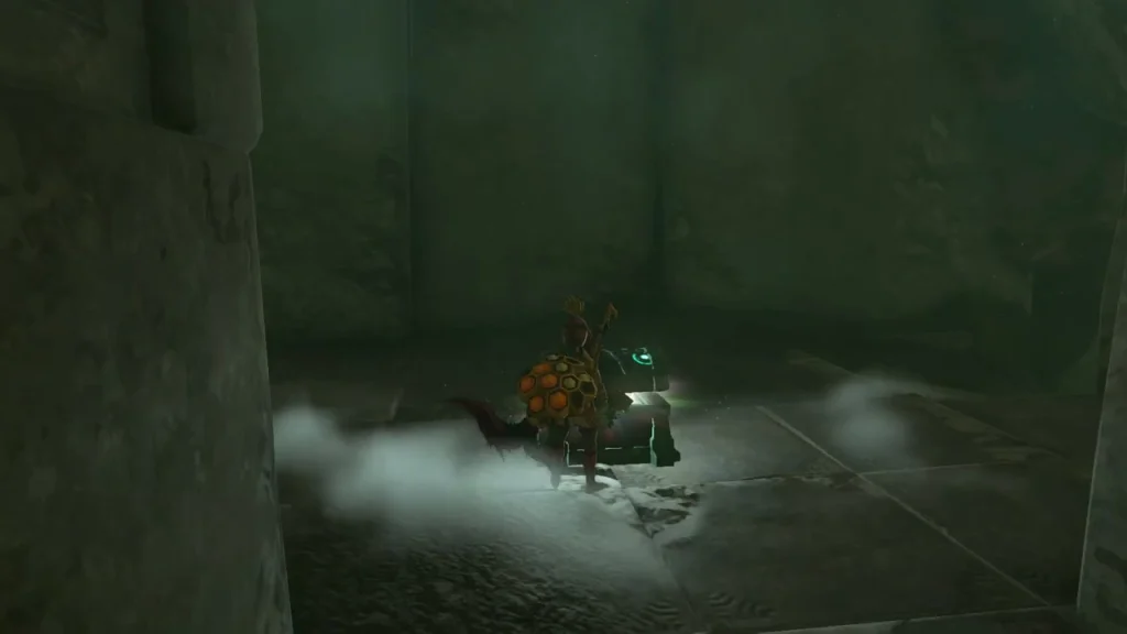 Chest being opened in a narrow stone chamber
