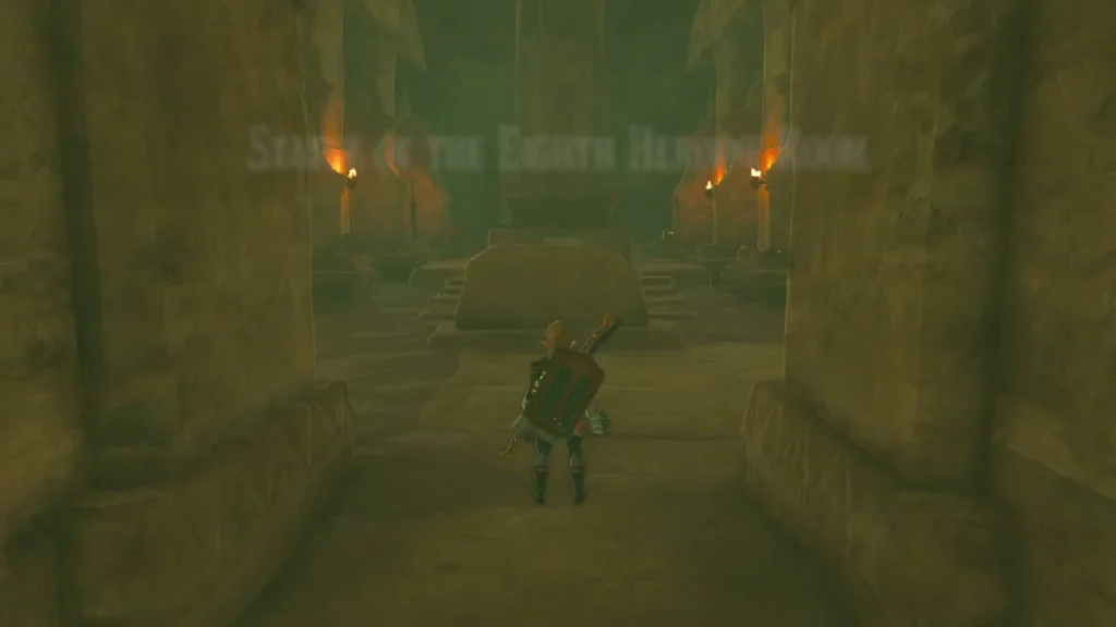 Torch-lit hall leading to the stone tablet