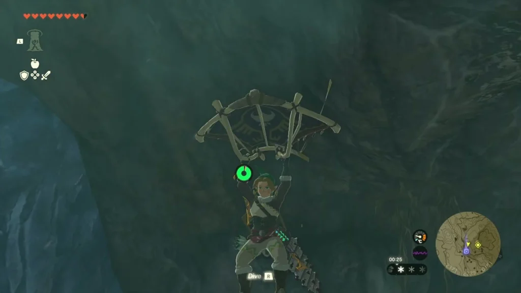 Glider open beside a rock wall in the cave
