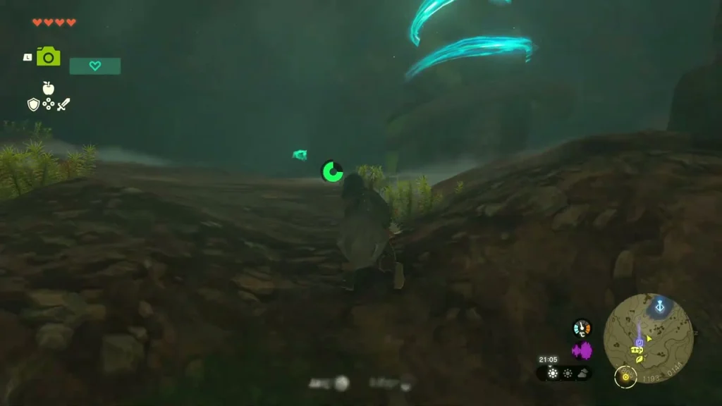 Teal shrine beam swirling above a dark rocky shelf at the top of the cave Teal shrine beam swirling above a dark rocky shelf at the top of the cave