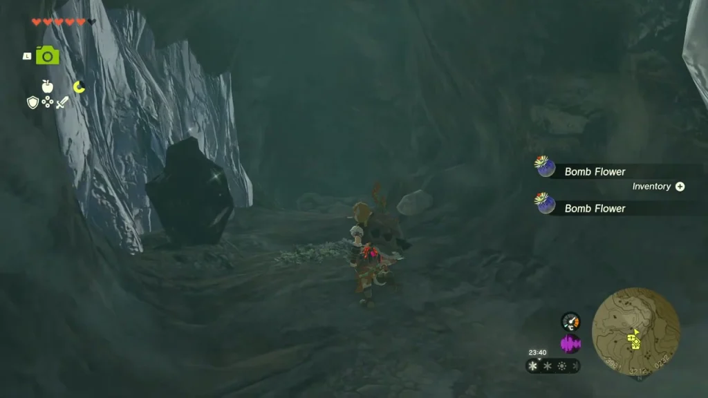 Cave mouth in an ice wall with a boulder inside