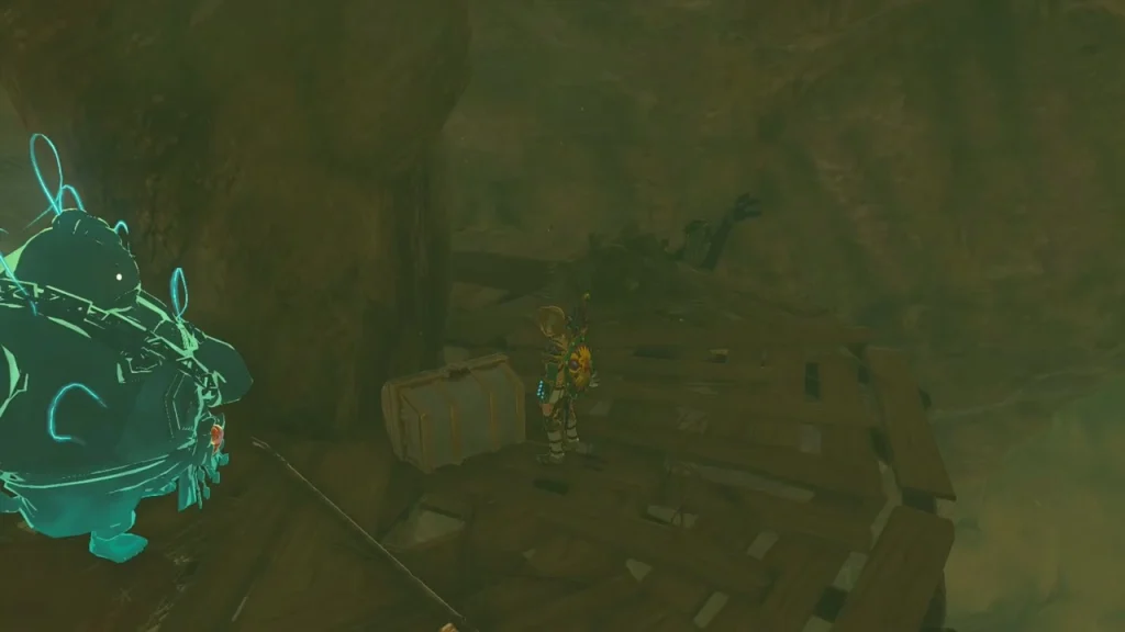 Treasure chest on a wooden platform beside a stone monster outline