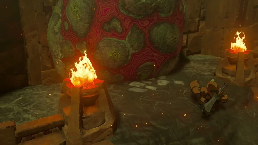 Red-veined boulder sealing the Fire Temple entrance beside a torch Red-veined boulder sealing the Fire Temple entrance beside a torch