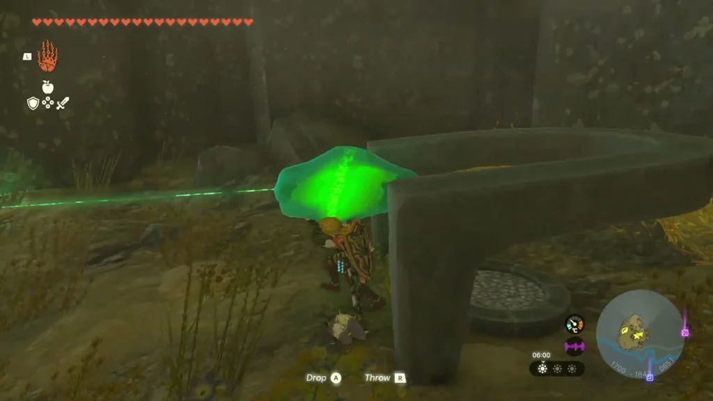 Green crystal held with Ultrahand beside a stone wall Green crystal held with Ultrahand beside a stone wall