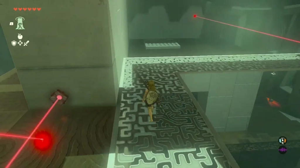 Laser emitter and beam beside a maze-patterned walkway
