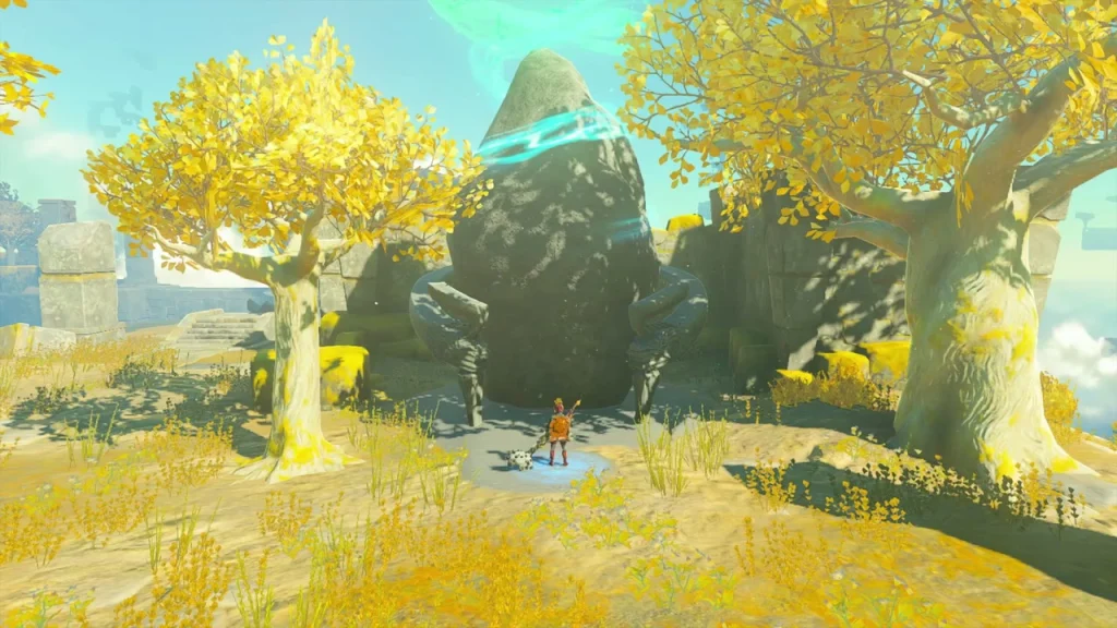 Rock outcrop between two yellow trees with the shrine entrance glow Rock outcrop between two yellow trees with the shrine entrance glow
