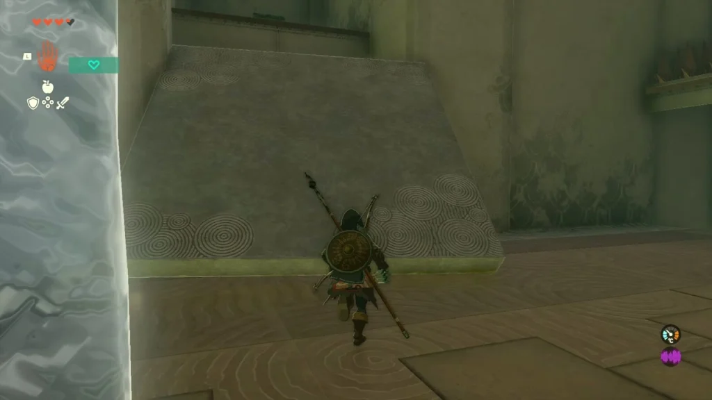 Ice block standing beside a tall stone wall that leads up to the chest room