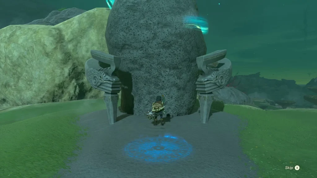 Shrine doorway between two carved stone fins with a blue platform on the path in front Shrine doorway between two carved stone fins with a blue platform on the path in front