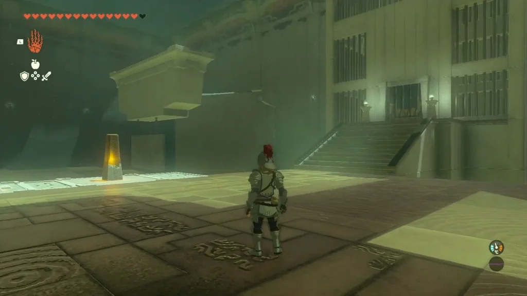 Open stone room with a glowing pillar and a staircase on the far side Open stone room with a glowing pillar and a staircase on the far side