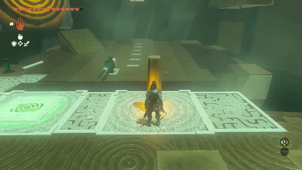 Floor switch beside the glowing orange pillar below the wall target Floor switch beside the glowing orange pillar below the wall target