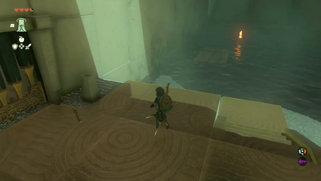 Landing with the wooden gate and a Torch on the floor beside the channel Landing with the wooden gate and a Torch on the floor beside the channel