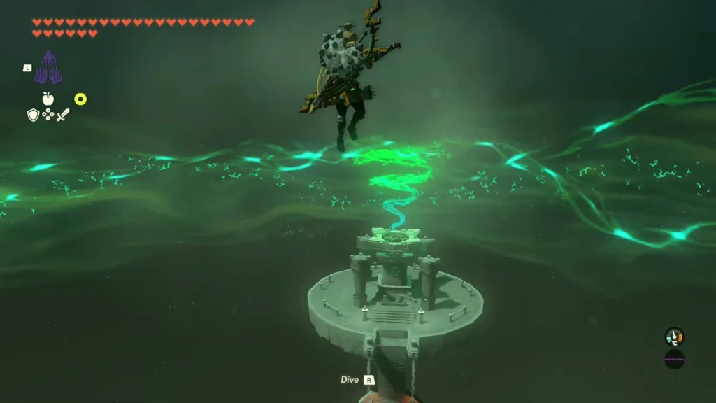 Round platform far below with a green glow at its centre Round platform far below with a green glow at its centre