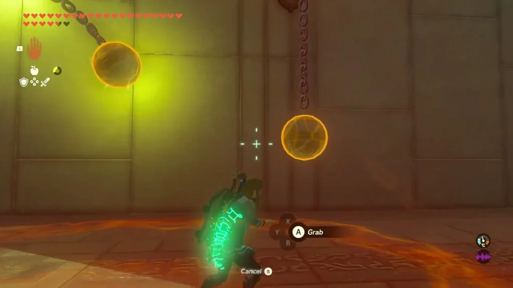 Metal balls on chains being grabbed in the yellow-lit hall
