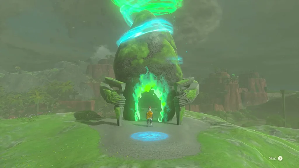 Shrine rock with a green entrance on a grassy cliff edge