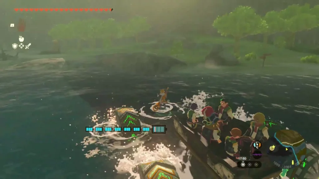 Boat with green fans carrying the troupe across the water