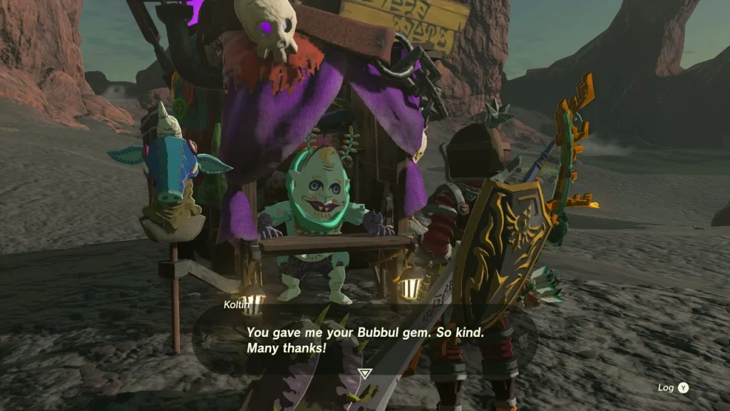 Koltin sitting behind his stall counter with a skull-topped awning