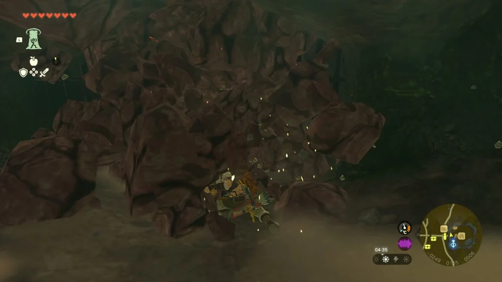 Brown boulder wall in the cave being broken apart