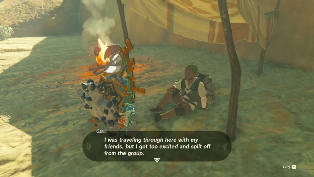Garill sitting in the shade of a tent awning