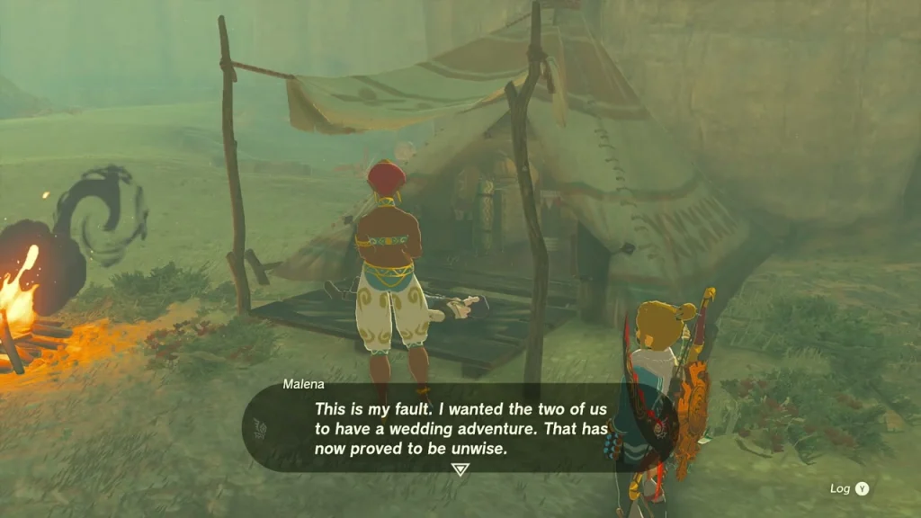 Malena standing under her tent beside a campfire