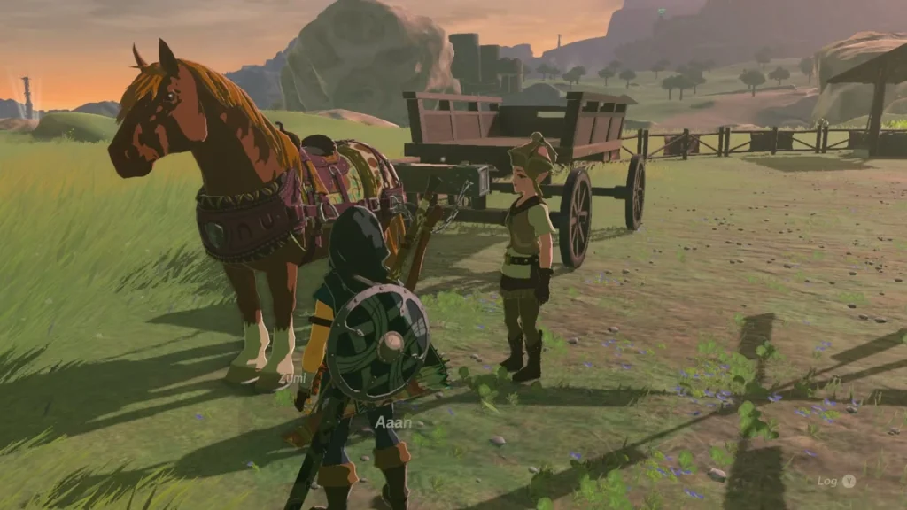 Horse harnessed to the wooden wagon on the grass at sunset Horse harnessed to the wooden wagon on the grass at sunset